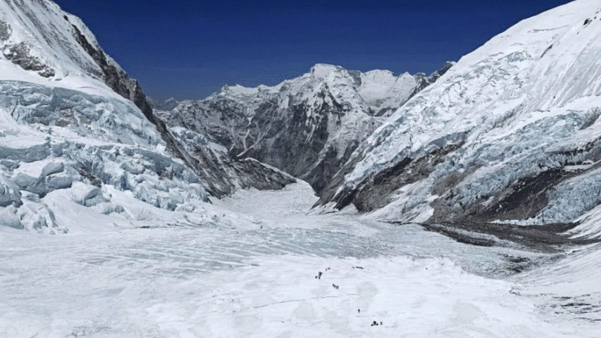 A glacier valley in the Hindu Kush Himalaya, with figures crossing the ice
